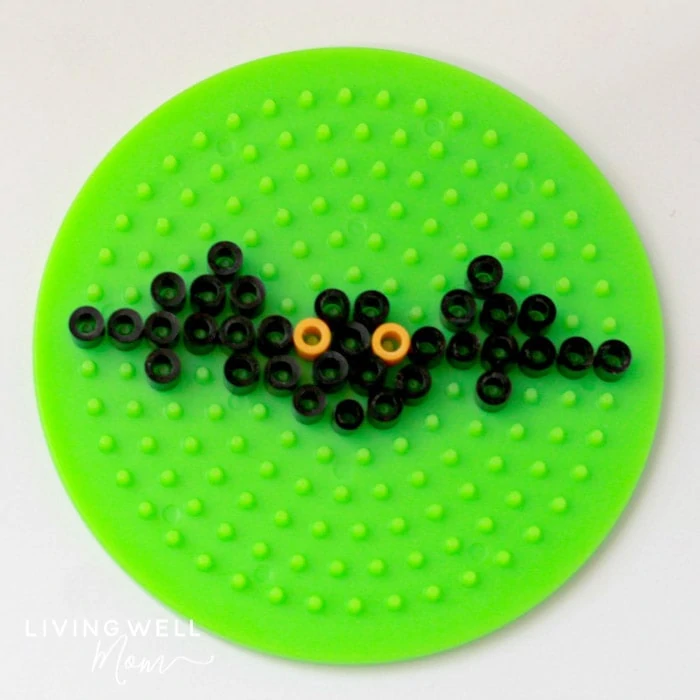 bat perler bead pattern on green board