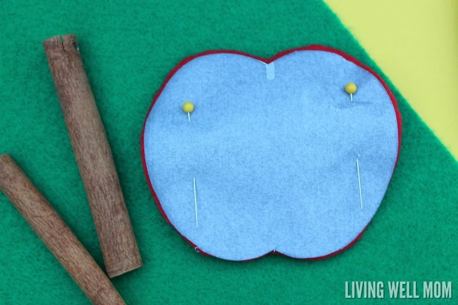 These Felt Apple Ornaments are easy for kids to put together and they have a secret - they're cinnamon-scented! Perfect for a homemade teacher gift, these DIY ornaments are a great craft activity for kids or a first sewing project.