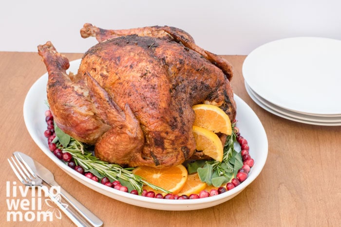 orange slices and lettuce garnishing a roasted turkey