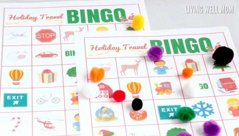 two holiday car bingo printable cards with pompoms used as markers