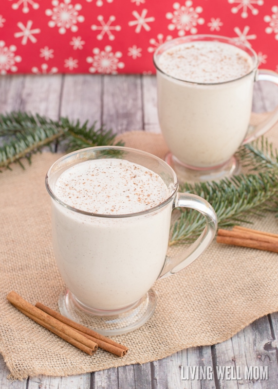 eggless vegan eggnog in a glass with cinnamon sticks and pine branches