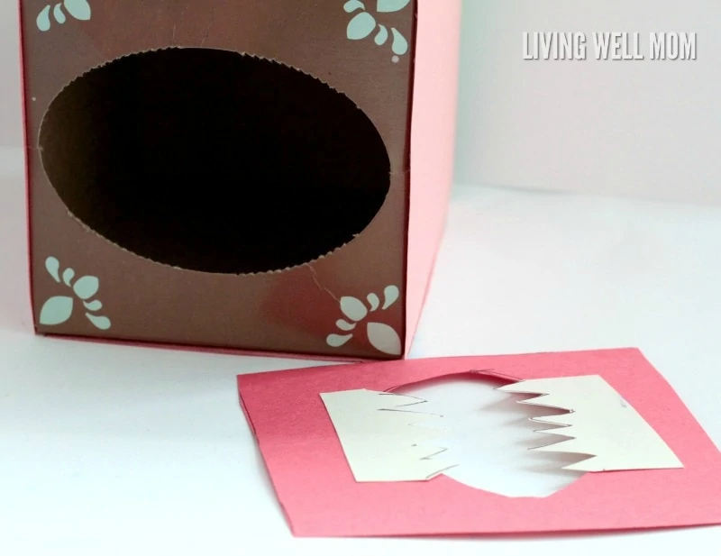 tissue box and paper to make DIY valentine's card mailbox