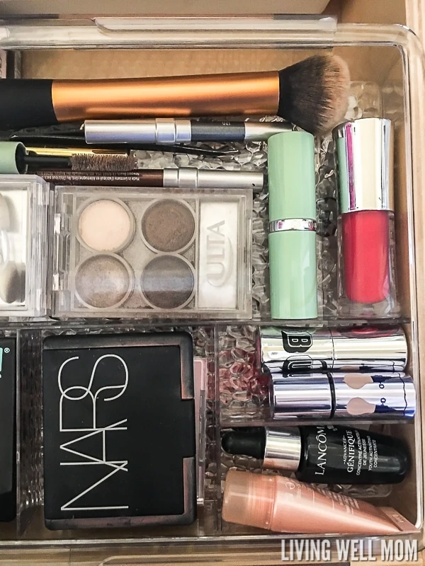 Overhead shot of makeup in a clear drawer organizer