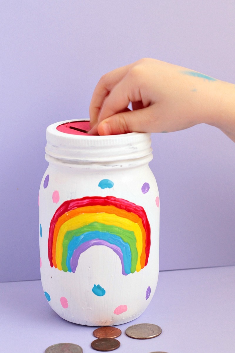 This DIY rainbow mason jar piggy bank is easy enough for kids to make themselves! It’s a fun, colorful way to encourage kids to save money. 