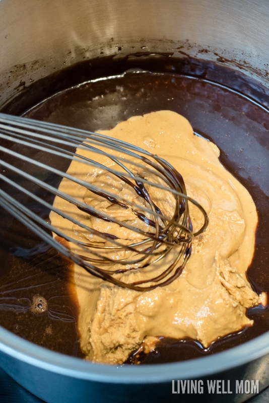 heaps of peanut butter being added into chocolate mixture 