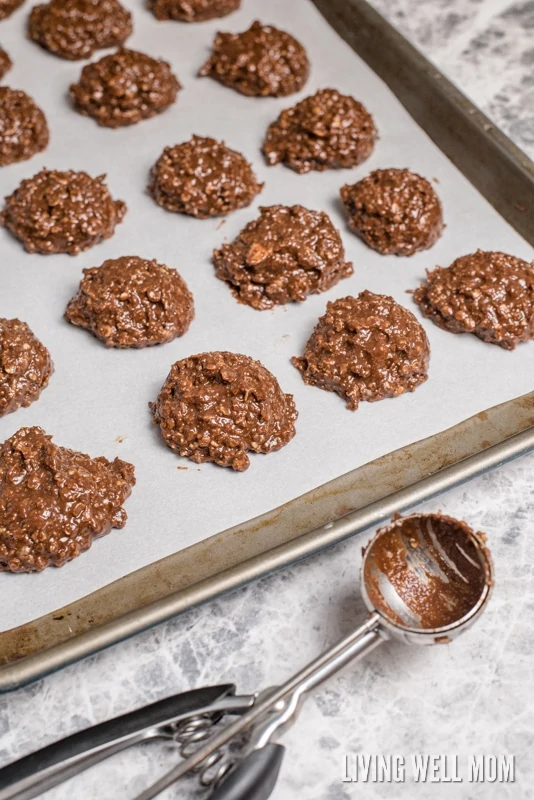 scoops of cookie dough dropped onto a sheet pan covered in parchment paper