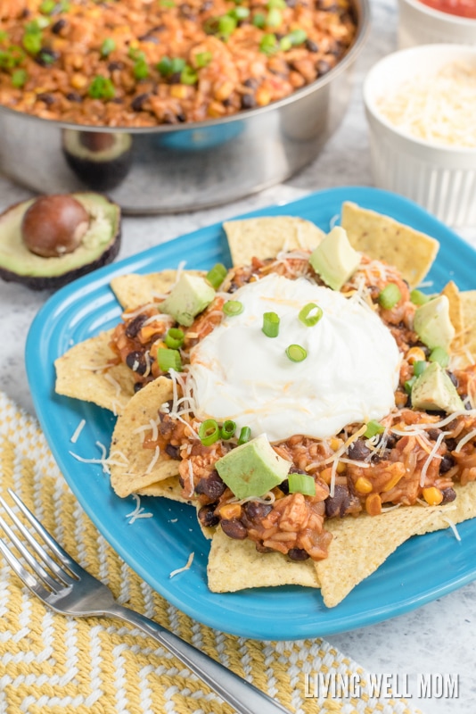 Mexican turkey casserole on top of a bed of tortilla chips, making enchilada nachos. 