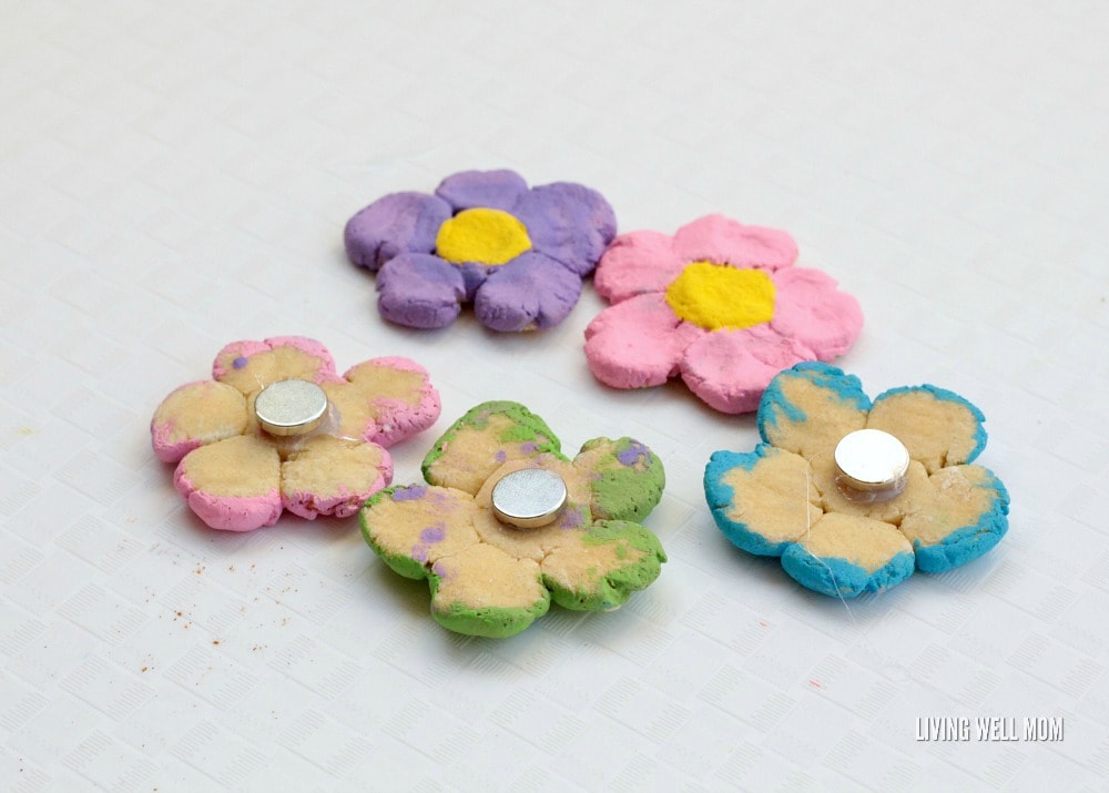 Delightful salt dough flower magnets are the perfect way to preserve your children's fingerprints in a fun, spring-themed project! Kids will love this fun activity!