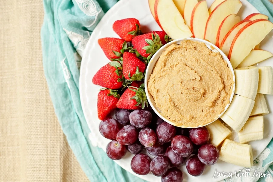 peanut butter dip in the center of a plate of fruit