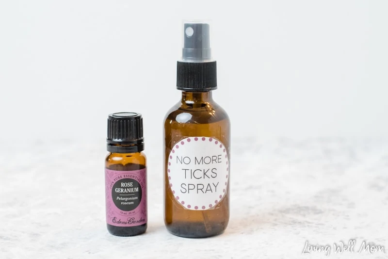 no more ticks glass spray bottle and rose geranium essential oil bottle with white background