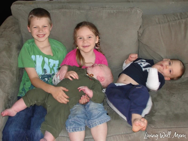 four children sitting on a coach 