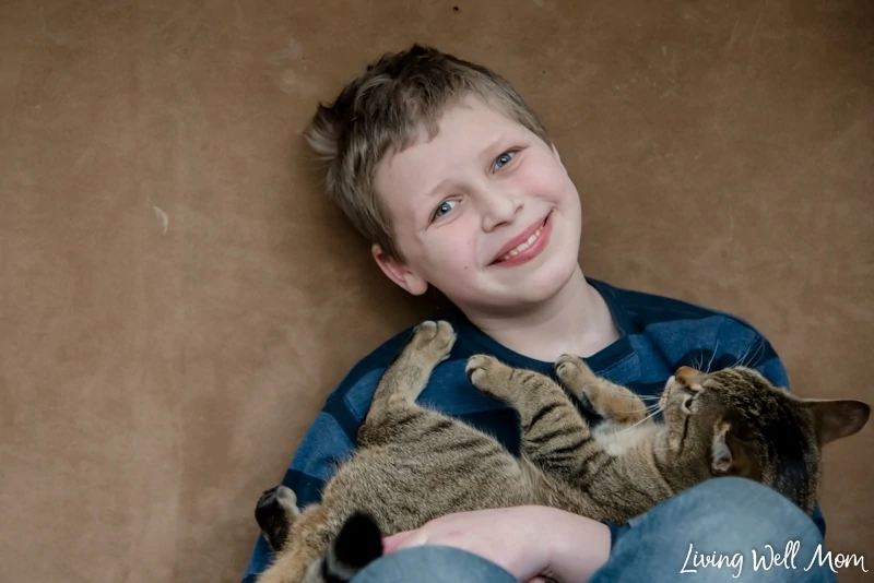 A young boy holding a cat