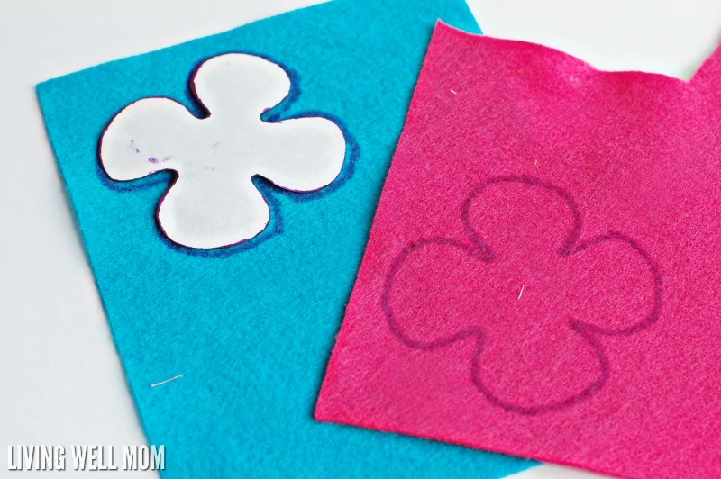 blue and pink sheets of felt with flower cutouts