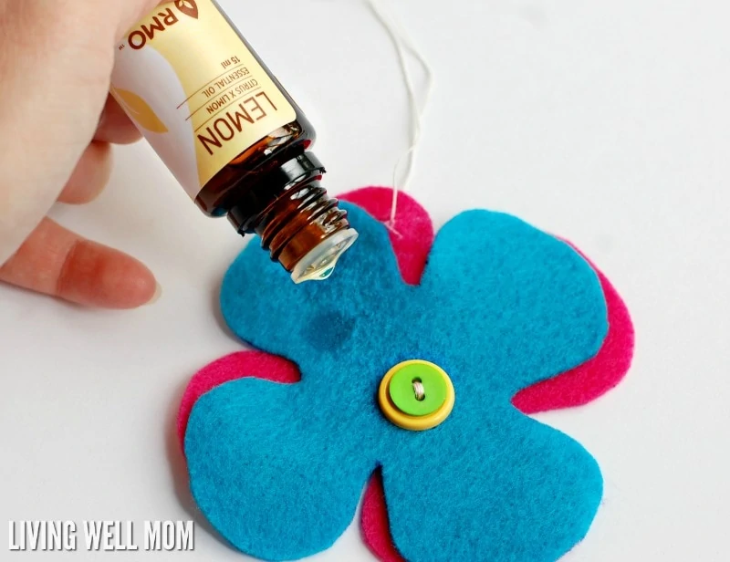 lemon essential oil being added to felt for diffusing car scents