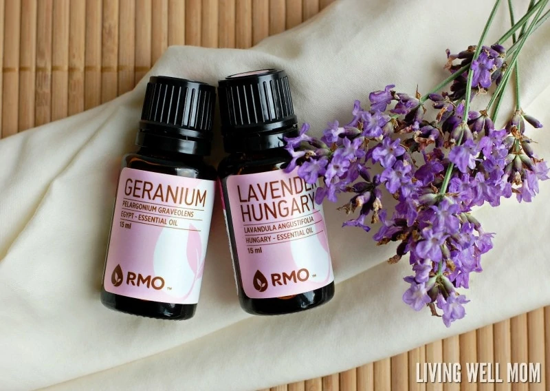 lavender and geranium essential oils next to flowers