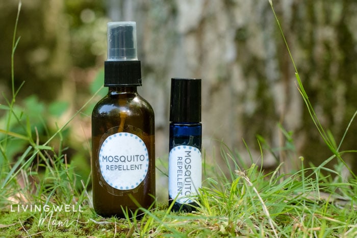homemade essential oil mosquito spray and roller in woods