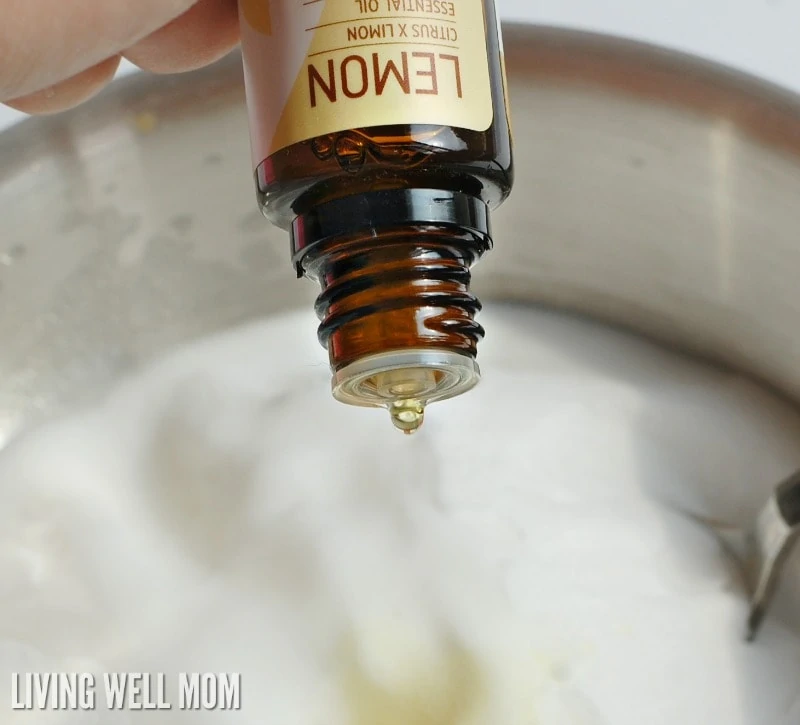drops of lemon essential oil being added into mixing bowl