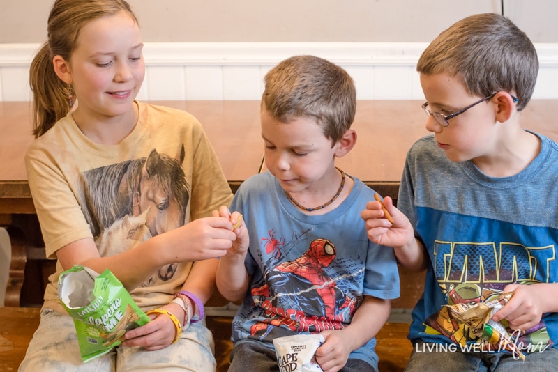 my kids enjoying their snack packs which is one tip for making packing school lunches easier