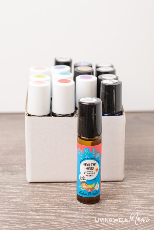 essential oil rollerball bottles on a table and in a white cardboard box