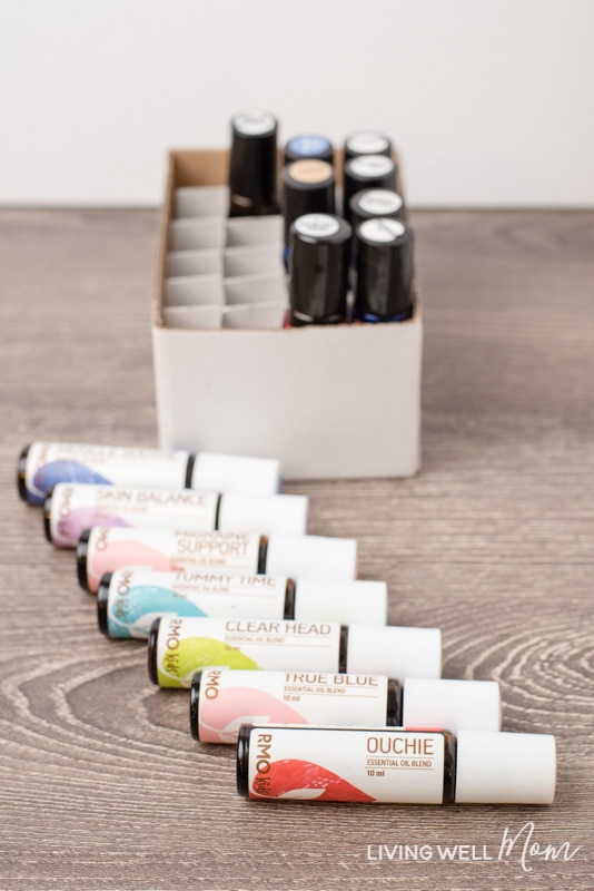 essential oil rollerball bottles on a table and in a white cardboard box