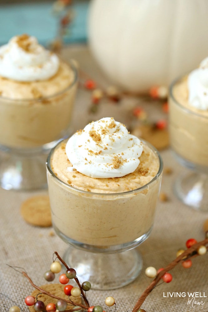 Whipped pumpkin spice mousse in glass cup topped with whipped cream