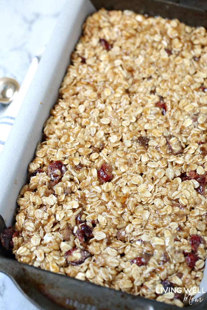 Cranberry Granola Bar Squares are a nutritious, moist, chewy granola bar square filled with oats, crispy rice, and dried cranberries. This is an easy, delicious, gluten-free and dairy-free snack recipe kids love!