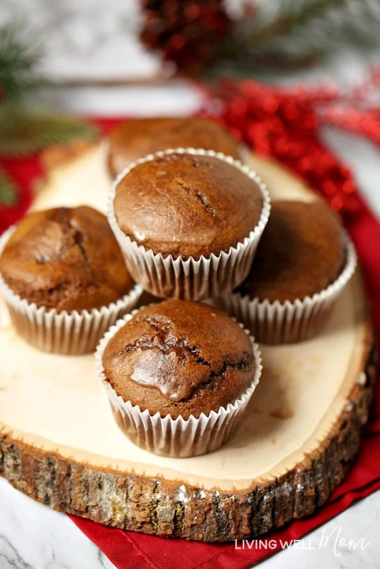 gluten-free glazed gingerbread muffins on a log with Christmas decorations