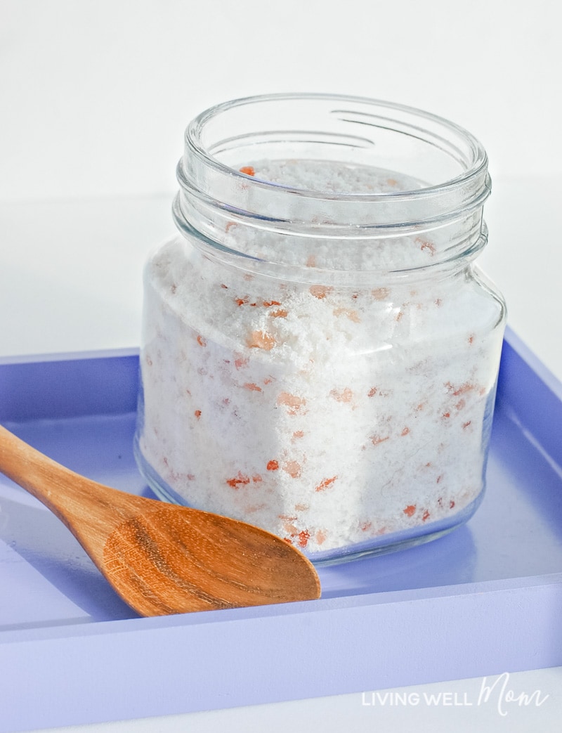 Calming lavender bath salts in small jar with wooden spoon