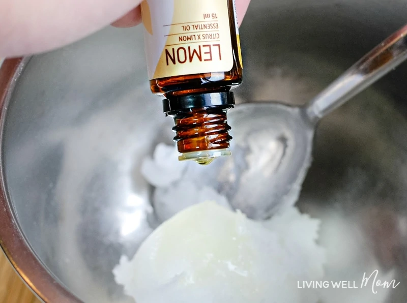 Adding lemon essential oil to coconut oil