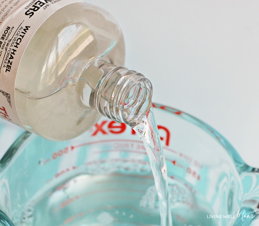 Witch hazel being poured into a measuring cup. 