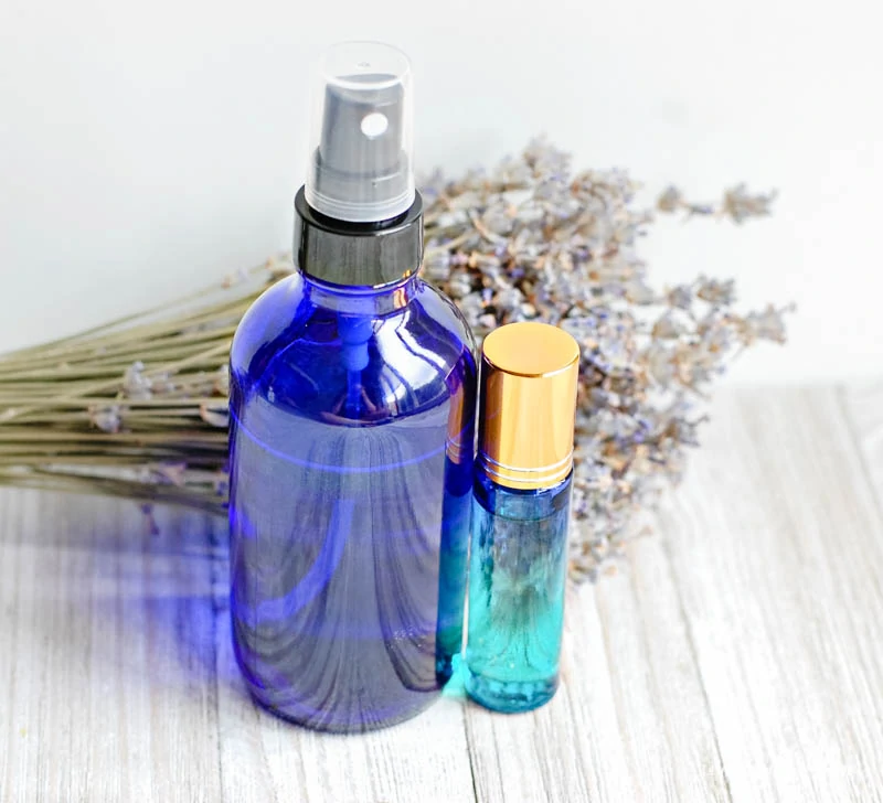 spray bottle next to roller ball of my bend of calming oils for kids