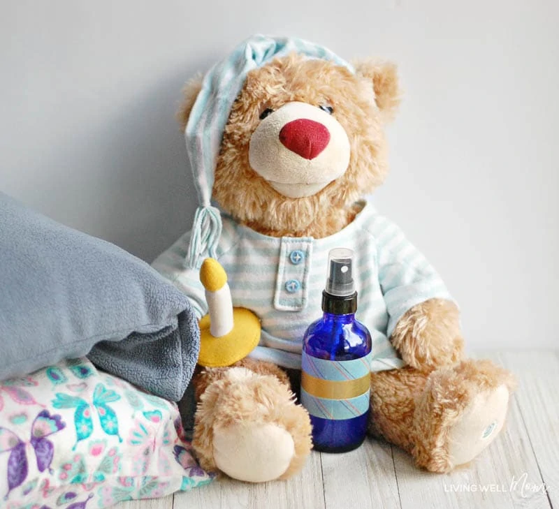 homemade pillow spray for kids with autism in a bottle next to stuffed teddy bear