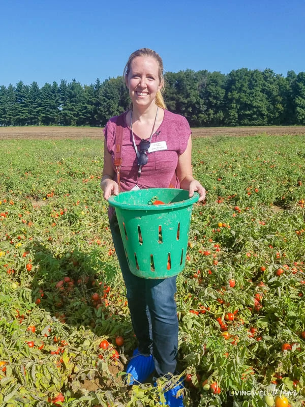 Erika Bragdon standing in front of a tomato field