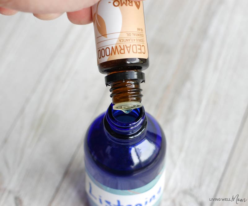 essential oils being poured into and spray bottle 