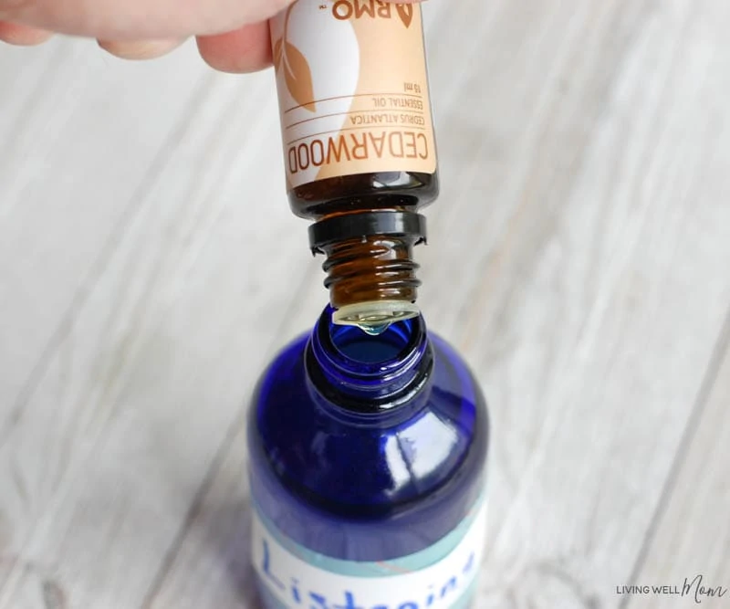 drops of essential oils for focus being poured into and spray bottle 