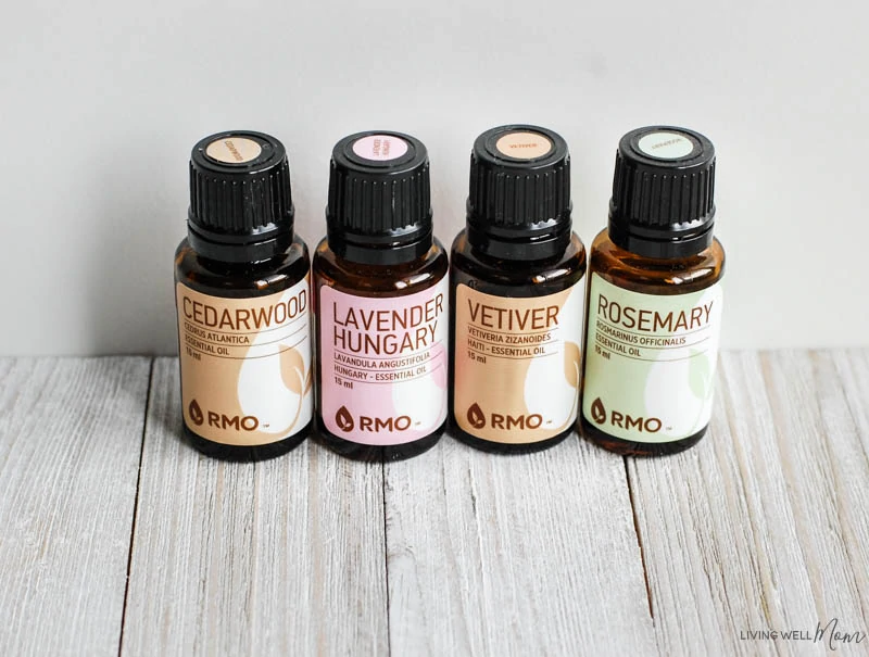 a close up of four essential oil bottles on a table