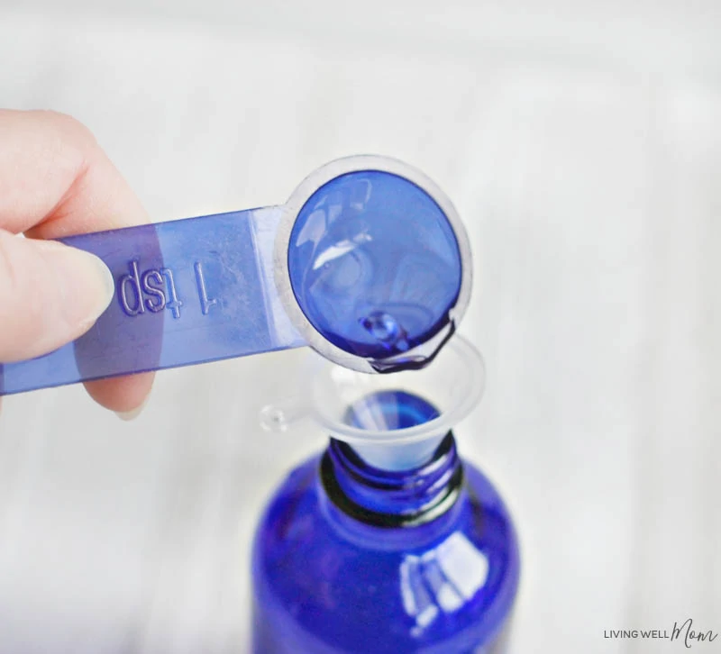 a liquid being poured into a spray bottle 