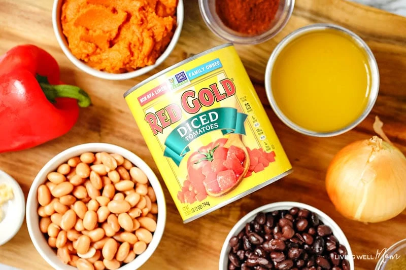 canned diced tomatoes in the center of other pumpkin chili ingredients