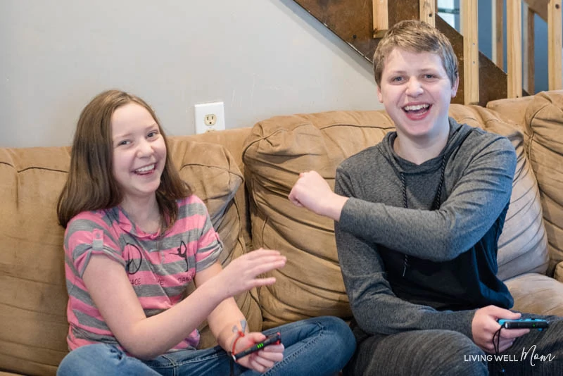 a boy and a girl sitting on a couch