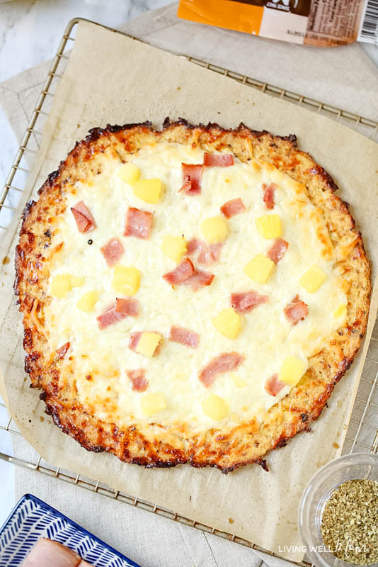 A freshly baked ham and pineapple pizza with a cauliflower crust. 