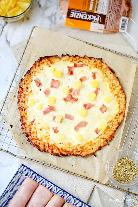 Pineapple tidbits added on top of Hawaiian low-carb pizza. 