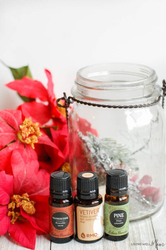 some essential oils, a spray bottle, and a glass jar 