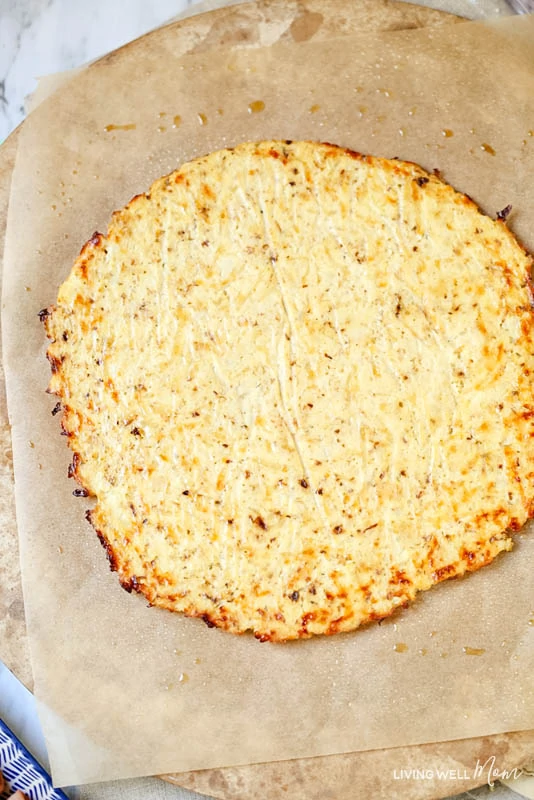 Baked grain-free pizza crust made with cauliflower and mozzarella cheese. 