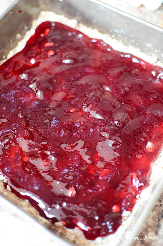 Raspberry jam over an oatmeal bar base