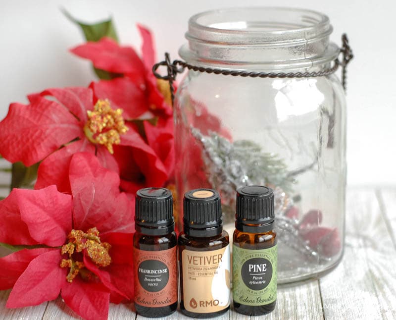 some essential oils, a spray bottle, and a glass jar 