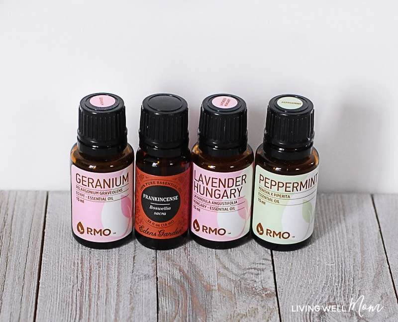 bottles of geranium, frankincense, lavender, and peppermint oil 