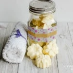 small homemade energizing Aromatherapy shower steamers in a glass jar