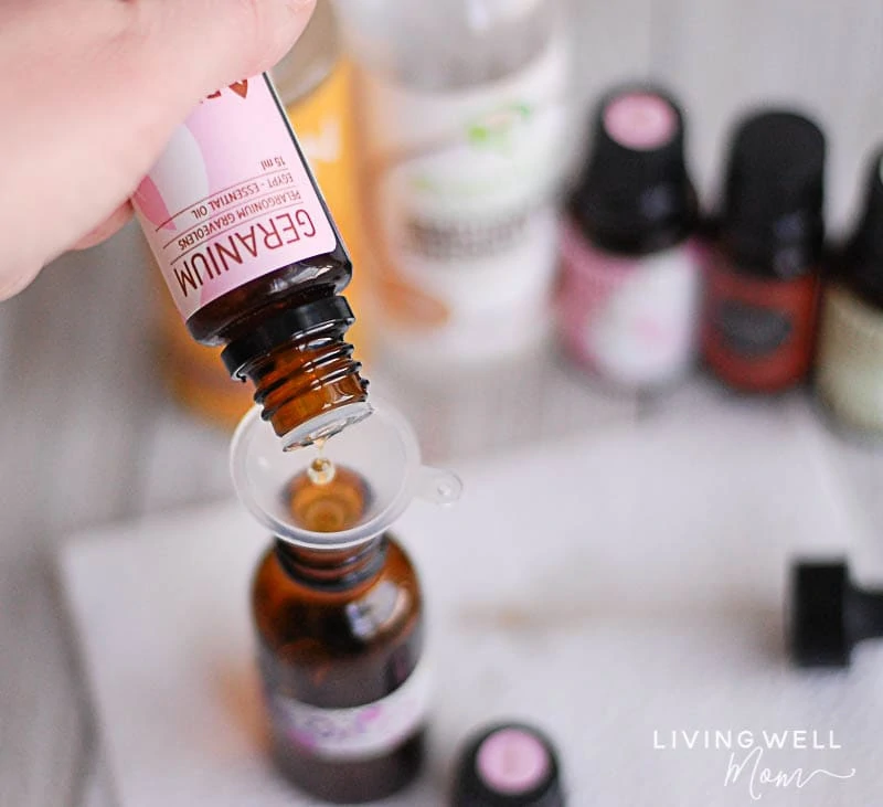 geranium essential oil being dropped into dropper bottle