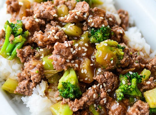 broccoli with ground beef and rice on a white plate