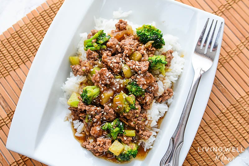 gluten free beef and broccoli with sesame seeds on a white plate